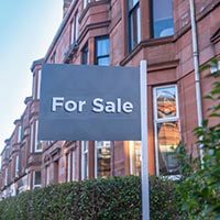 A For Sale Sign Outside A Traditional Red Sandstone Tenement Flat (Apartment) In Glasgow
